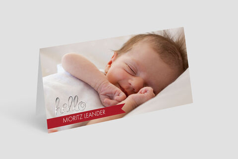 Creatieve kaart met een babyarm en de liefdevolle tekst 'Hallo Moritz Leander'.