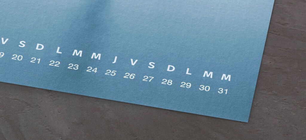 Un calendrier photo CEWE affichant les jours du mois en blanc sur fond bleu.