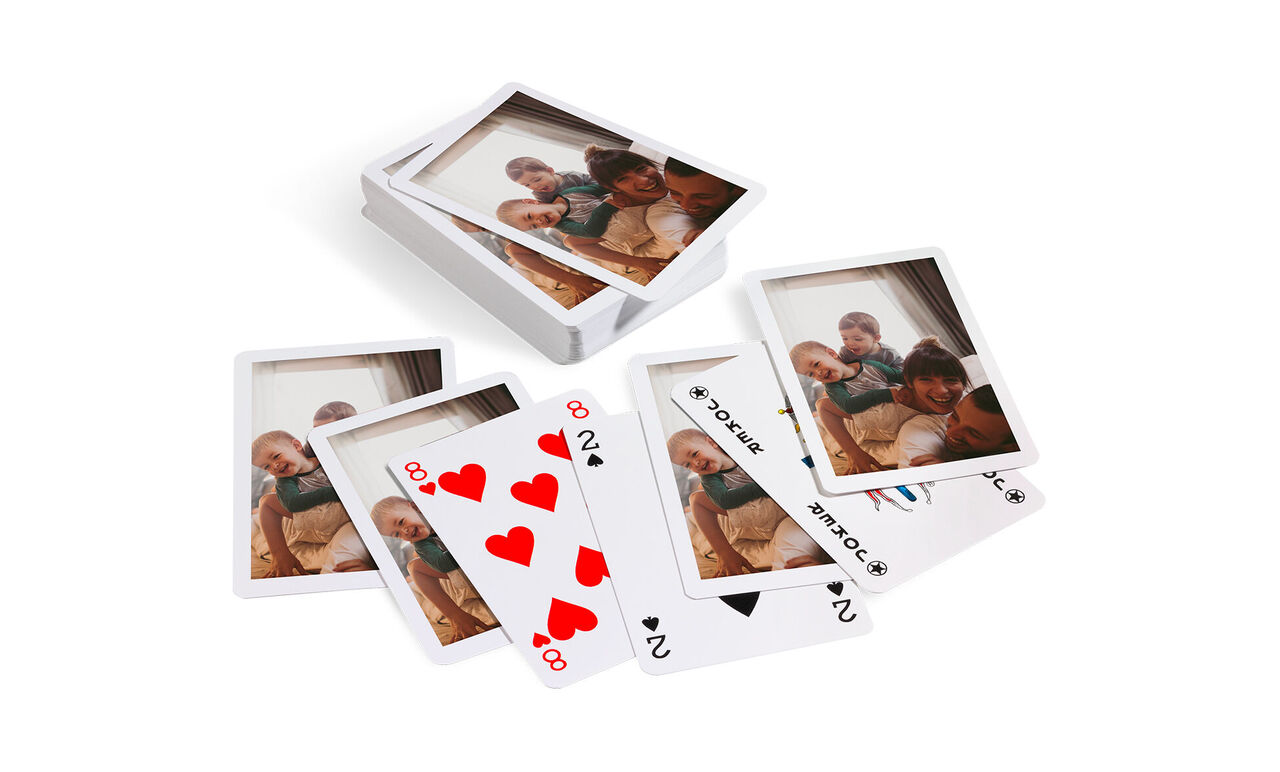 Une pile de cartes de jeu personnalisées avec des photos. Certaines cartes montrent des moments heureux avec des amis et la famille. Chaque carte montre des images évoquant joie et souvenirs personnels.