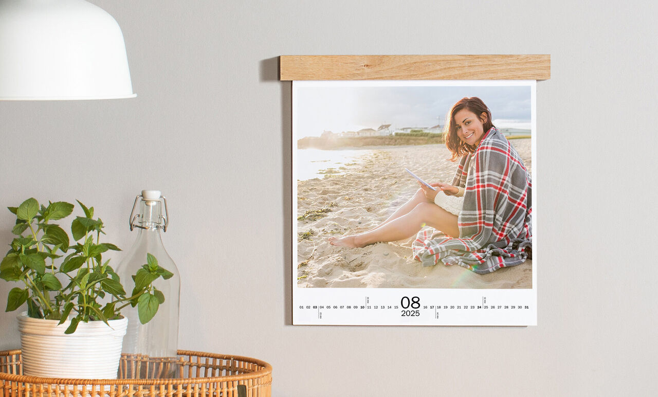 Personne est détendue sur la plage avec un livre dans le calendrier CEWE d'août 2025