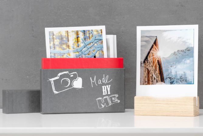 Une boîte créative avec des photos montrant des souvenirs, incluant une enveloppe blanche
